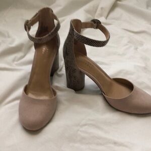 Dressy ankle strapped 3” chunky heel with snakeskin design and suede like toe.